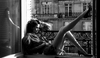 Woman Sitting Near The Window
