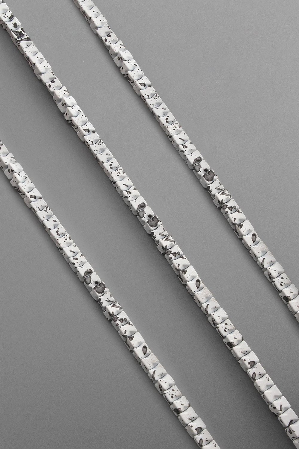 Hematite Natural Stone Matte Mottled White Cube Cut 4x4mm String Of Beads