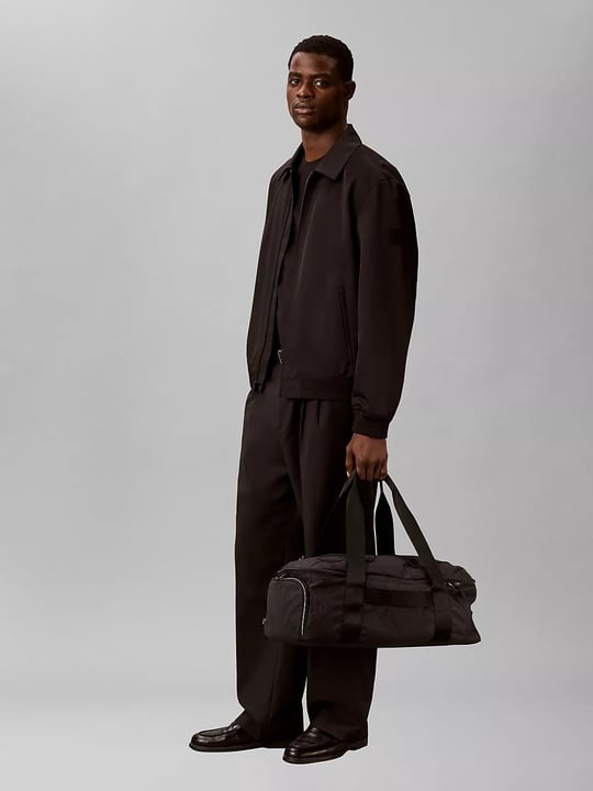 Calvin Klein Calvin Klein Erkek Logo Baskılı Fermuar Bölmeli Geniş İç Hacimli Siyah Seyahat Çantası LV04D3385G-UB1
