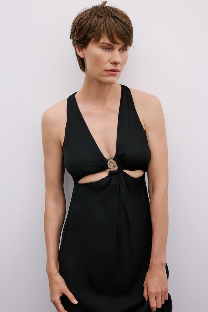 Long Black Cut-Out Dress with Gold Accessories
